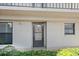 Image of the front door with surrounding green bushes and plants at 1001 Benjamin Franklin Dr # 106, Sarasota, FL 34236