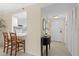 Hallway featuring tile floors with a view of the kitchen and entryway at 1001 Benjamin Franklin Dr # 106, Sarasota, FL 34236