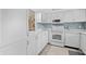 Bright kitchen with white cabinetry, tile flooring, and stainless-steel appliances at 1001 Benjamin Franklin Dr # 106, Sarasota, FL 34236