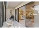 Spacious lanai with a seahorse decoration and a view of the living room through sliding glass doors at 1001 Benjamin Franklin Dr # 106, Sarasota, FL 34236