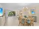 Well-lit living room and dining area with sliders to lanai, great for entertaining at 1001 Benjamin Franklin Dr # 106, Sarasota, FL 34236