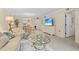 Living room featuring tile floors, neutral paint, and access to other rooms at 1001 Benjamin Franklin Dr # 106, Sarasota, FL 34236