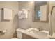 Cozy bathroom featuring a modern vanity with marble countertop and a mirrored wall cabinet at 105 Casey Key Rd # 20, Nokomis, FL 34275