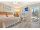 Cozy bedroom with a comfortable bed, TV, and convenient access to the outdoors at 105 Casey Key Rd # 20, Nokomis, FL 34275