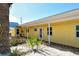 Charming yellow condo building featuring lovely landscaping with a sandy walkway leading to the unit at 105 Casey Key Rd # 20, Nokomis, FL 34275