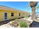 Cozy beach condo exterior with well-maintained landscaping, sandy ground, and a lovely view of the beach at 105 Casey Key Rd # 20, Nokomis, FL 34275
