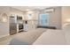 Efficient kitchenette with stainless steel appliances, white cabinets, and space-saving design at 105 Casey Key Rd # 20, Nokomis, FL 34275