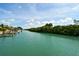 Scenic waterfront view of a canal lined with lush mangroves and private boat docks at 105 Casey Key Rd # 20, Nokomis, FL 34275