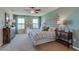 Bright bedroom with decorative headboard, complemented by ample natural light and serene ambiance at 10832 Gentle Current Way, Parrish, FL 34219