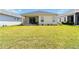 Expansive backyard with lush green grass and a covered patio perfect for entertaining at 10926 Sand Pine Ln, Parrish, FL 34219