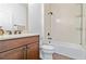 Bathroom features a dark wood vanity with a shower and tub combination at 10926 Sand Pine Ln, Parrish, FL 34219