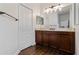 Bathroom boasts a dark wood vanity with ample counter space and a framed mirror at 10926 Sand Pine Ln, Parrish, FL 34219