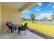 Cozy patio seating overlooking a serene lake and well-manicured lawn at 10926 Sand Pine Ln, Parrish, FL 34219
