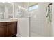 Shower with tiled walls, glass partition, and a window allowing for natural light at 10926 Sand Pine Ln, Parrish, FL 34219