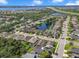 Aerial view of the neighborhood with homes surrounding a pond near a busy highway at 110 San Lorenzo Ct, Bradenton, FL 34208