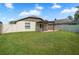 View of the backyard with a pergola on a brick patio and green grass for outdoor enjoyment at 110 San Lorenzo Ct, Bradenton, FL 34208