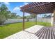 Spacious backyard featuring a pergola, brick paver patio and lush green grass at 110 San Lorenzo Ct, Bradenton, FL 34208