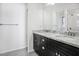 Modern bathroom featuring double vanity with marble countertop and dark cabinetry at 110 San Lorenzo Ct, Bradenton, FL 34208
