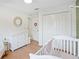 Light-filled Bedroom featuring white furniture, wood floors, and a charming decor at 110 San Lorenzo Ct, Bradenton, FL 34208
