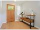 Welcoming entryway featuring hardwood floors, a wooden door with glass, and a stylish console table at 110 San Lorenzo Ct, Bradenton, FL 34208