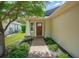 Inviting front entrance with a brick walkway, garden beds, and a charming wood door with glass inserts at 110 San Lorenzo Ct, Bradenton, FL 34208