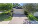 Charming home with a two-car garage and brick paver driveway surrounded by mature trees at 110 San Lorenzo Ct, Bradenton, FL 34208