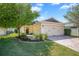 Charming single-Gathering home with a brick driveway, lush landscaping, and an attached two-car garage at 110 San Lorenzo Ct, Bradenton, FL 34208
