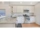 Updated kitchen featuring marble countertops, white cabinets, and stainless steel appliances at 110 San Lorenzo Ct, Bradenton, FL 34208