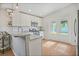 Well-lit kitchen featuring marble countertops, stainless steel appliances, and access to the backyard at 110 San Lorenzo Ct, Bradenton, FL 34208