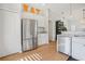 Kitchen featuring stainless steel appliances, white cabinets, and tile backsplash at 110 San Lorenzo Ct, Bradenton, FL 34208