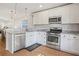 Kitchen with white cabinets, stainless steel appliances, and marble countertops at 110 San Lorenzo Ct, Bradenton, FL 34208