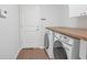 Functional laundry room with wooden countertop and modern washer and dryer units at 110 San Lorenzo Ct, Bradenton, FL 34208