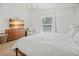 Well-lit main bedroom featuring wood-look floors, a window, and contemporary furnishings at 110 San Lorenzo Ct, Bradenton, FL 34208