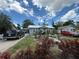 Charming single-story home with a metal roof, complemented by a landscaped front yard at 1113 23Rd W Ave, Bradenton, FL 34205