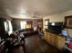 Cozy living room featuring hardwood floors, a ceiling fan, and comfortable leather furniture at 1113 23Rd W Ave, Bradenton, FL 34205