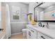 Bright bathroom with a white vanity, dark hardware, stylish wall decor, and a shower/tub combination at 11410 57Th E St, Parrish, FL 34219