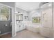 Light-filled bathroom features dual sinks, a soaking tub, and a separate glass shower at 11410 57Th E St, Parrish, FL 34219