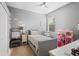 Cozy bedroom with neutral tones, featuring a twin bed, a ceiling fan, and playful decor at 11410 57Th E St, Parrish, FL 34219