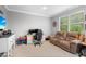 Versatile bonus room with a desk, comfortable seating, and natural light, perfect for work or relaxation at 11410 57Th E St, Parrish, FL 34219