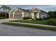 Beautiful one-story home showcasing manicured lawn and a gray exterior, complemented by a three-car garage at 11410 57Th E St, Parrish, FL 34219