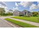 Charming single-story home featuring a lush lawn, a two-car garage, and a well-manicured garden at 11410 57Th E St, Parrish, FL 34219