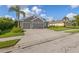 Well-maintained exterior showcasing a spacious driveway, two-car garage, and manicured landscaping at 11410 57Th E St, Parrish, FL 34219