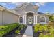 Inviting front entrance with decorative pillars and elegant landscaping leading to the front door at 11410 57Th E St, Parrish, FL 34219