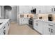 This well-lit kitchen features white cabinets, modern appliances, and sleek countertops at 11410 57Th E St, Parrish, FL 34219