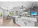 Kitchen island with a sink overlooks the dining area and an adjoining living room with plenty of natural light at 11410 57Th E St, Parrish, FL 34219