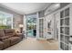 Living room featuring sliding glass doors offering views of the lanai and pool at 11410 57Th E St, Parrish, FL 34219