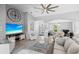 Spacious living room boasts high ceilings, a large ceiling fan, and lots of natural light at 11410 57Th E St, Parrish, FL 34219