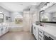 A spacious main bathroom with dual sinks, soaking tub, and a glass-enclosed shower at 11410 57Th E St, Parrish, FL 34219