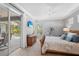 Cozy main bedroom featuring neutral walls, a ceiling fan, and sliding glass doors to the pool at 11410 57Th E St, Parrish, FL 34219