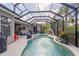 Screened-in pool area featuring a pool with water features and an outdoor seating area at 11410 57Th E St, Parrish, FL 34219
